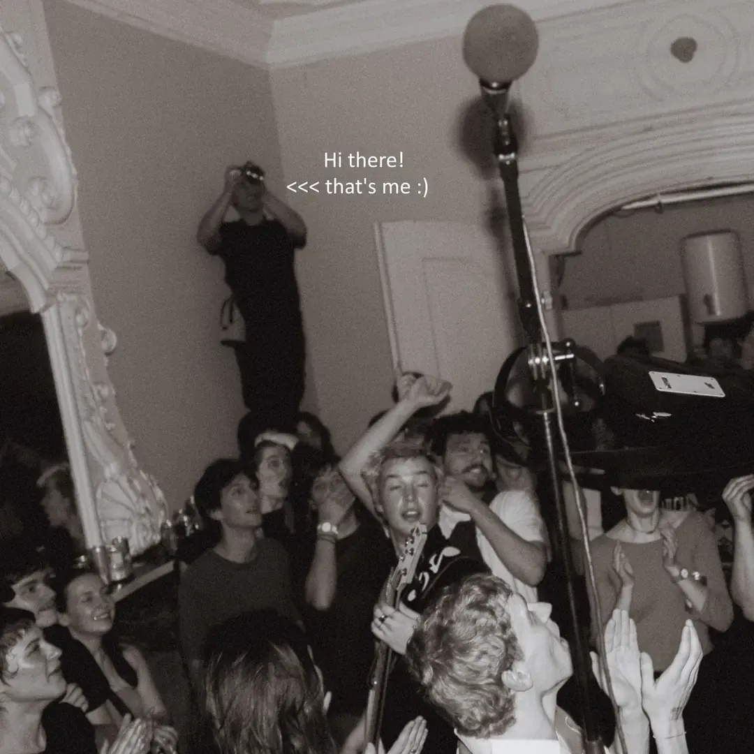 Photographer standing above the crowd at a party.